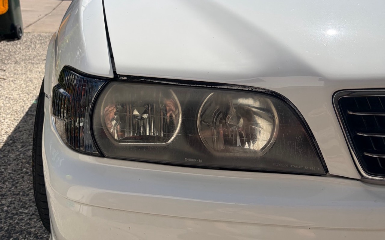 Hazy Toyota Chaser headlight before restoration